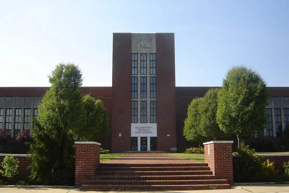 Mepham High School, a red brick building with entrance steps and trees in Bellmore, New York