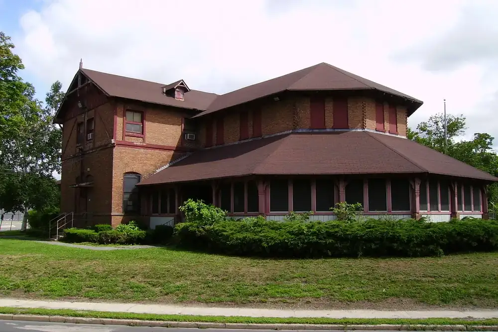 Brick recreation center with a pointed roof and a wide lawn in Central Islip, New York