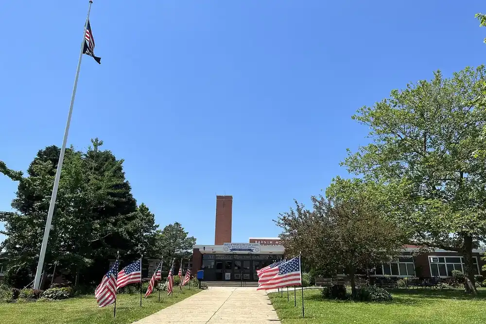 Barnum Woods Elementary School entrance with flags along a walkway in East Meadow, New York