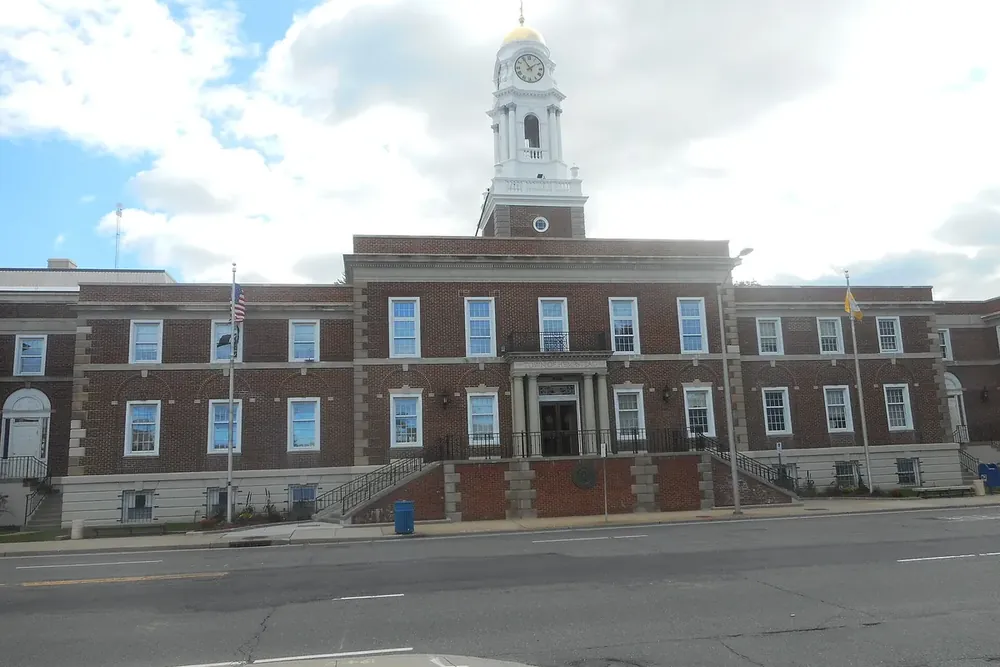 Historic Town of Hempstead Town Hall, a red brick building with a clock tower in Hempstead, New York